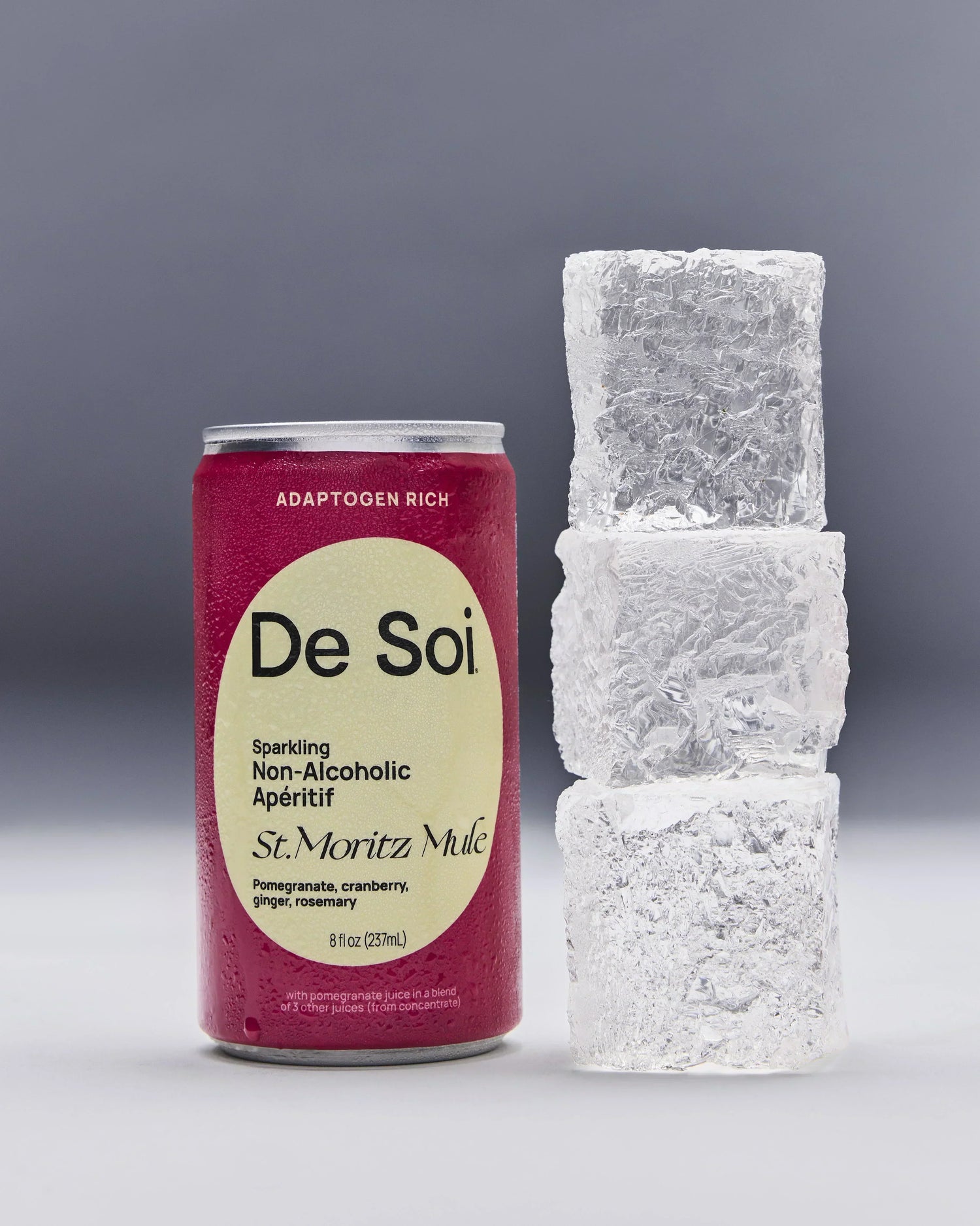 Non-alcoholic aperitif De Soi St. Moritz Mule can placed beside stacked ice cubes on a neutral background