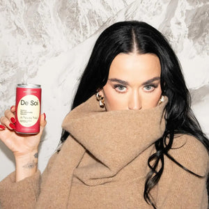 Adaptogen-infused mocktail highlighted with Katy Perry holding a can of De Soi St. Moritz Mule non-alcoholic aperitif