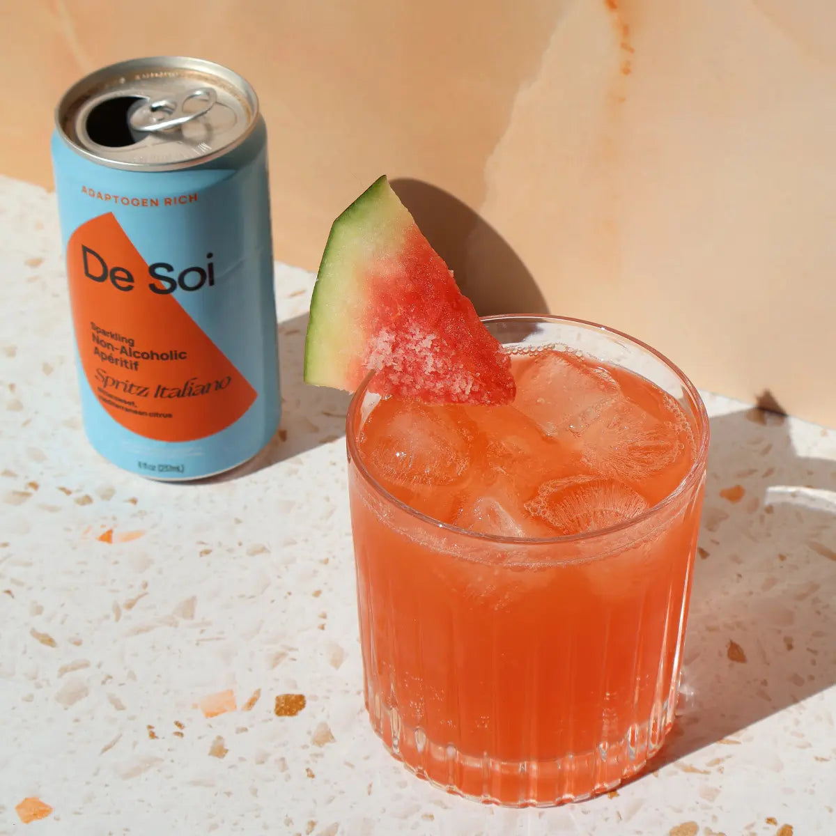 De Soi Spritz Italiano non-alcoholic aperitif poured over ice with a watermelon garnish.
