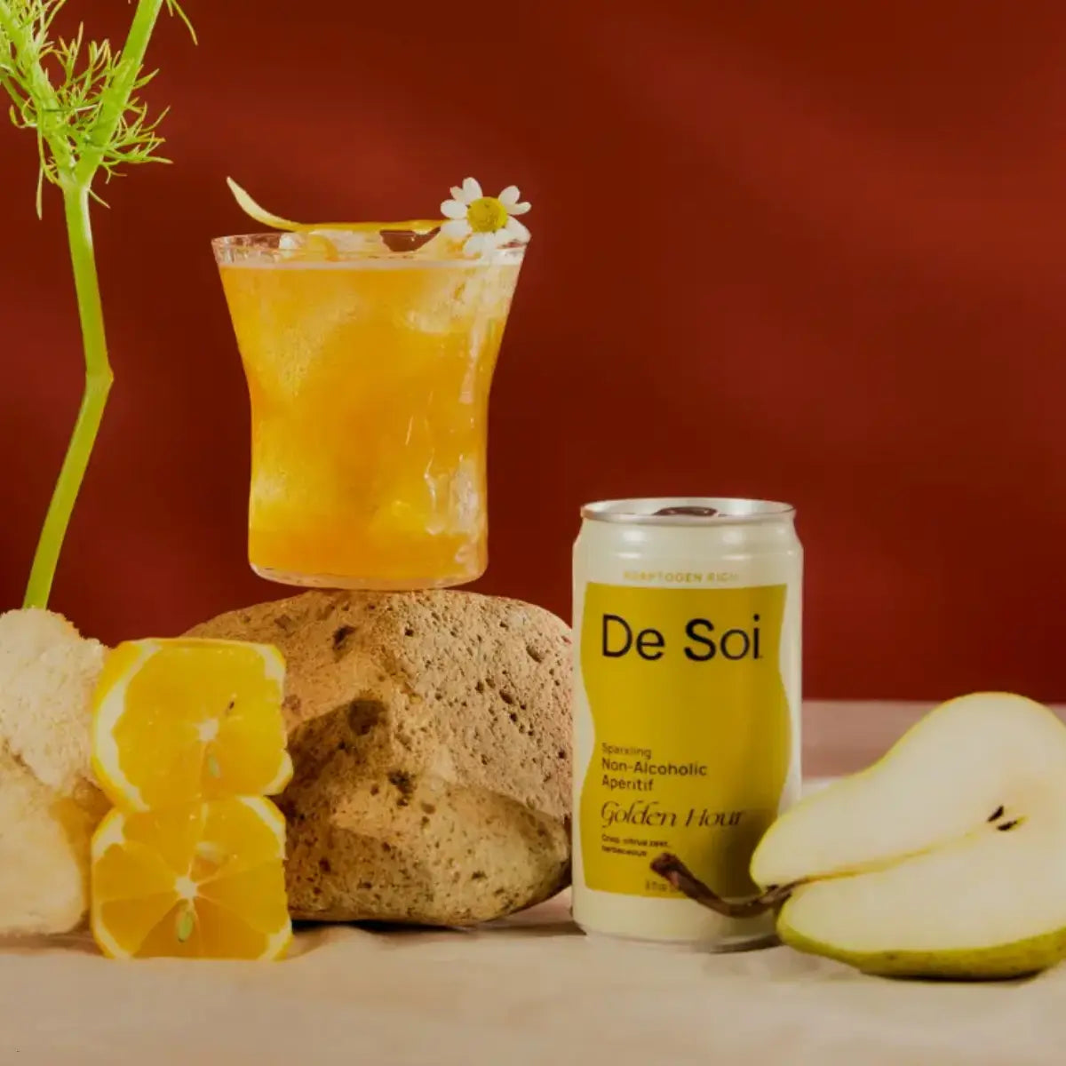 Functional mocktail for relaxation featuring De Soi Golden Hour with pear, orange slices, and calming chamomile garnish