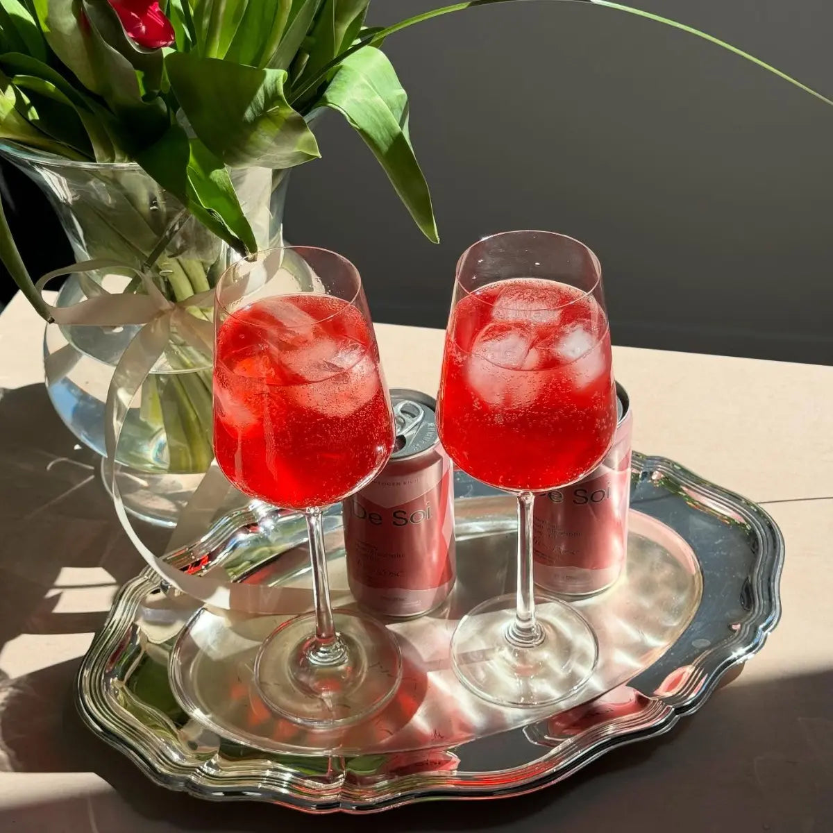 Non-alcoholic drinks featuring De Soi spritz served in wine glasses with ice on a silver tray