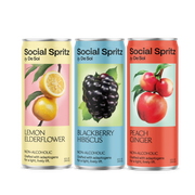 Three cans of Social Spritz by De Soi in Lemon Elderflower, Blackberry Hibiscus, and Peach Ginger, non-alcoholic adaptogen drinks lined up in a row.