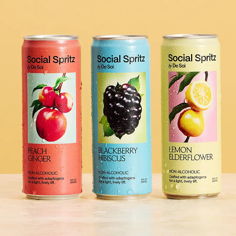 Three De Soi Social Spritz non-alcoholic adaptogen drinks in peach ginger, blackberry hibiscus, lemon elderflower.